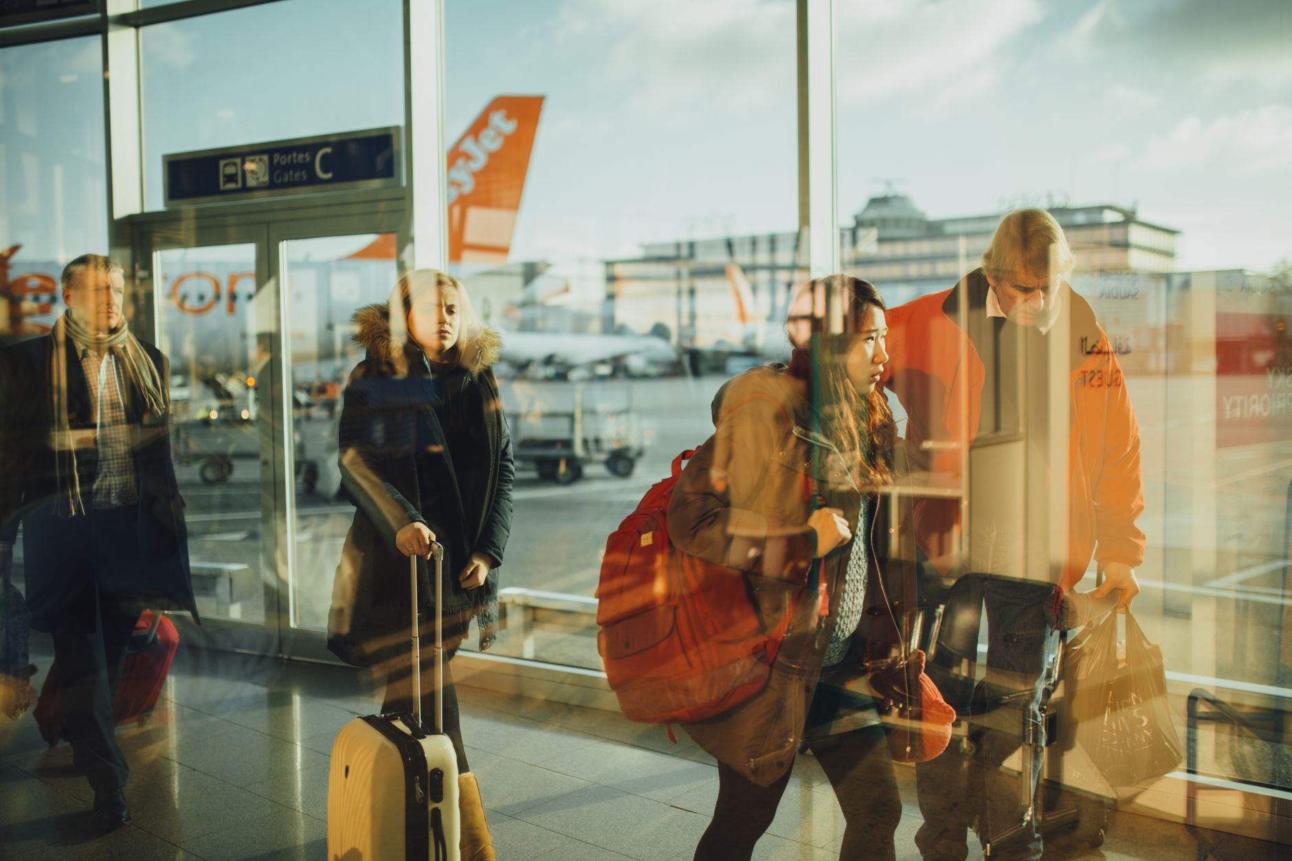 Travelers walking through Denver International Airport terminal