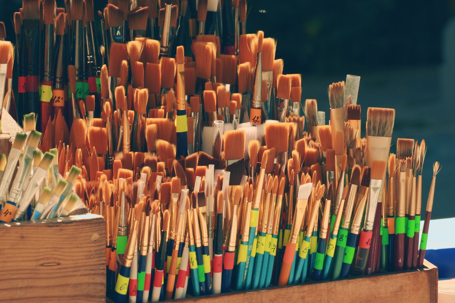 Paint brushes and art supplies on a work table