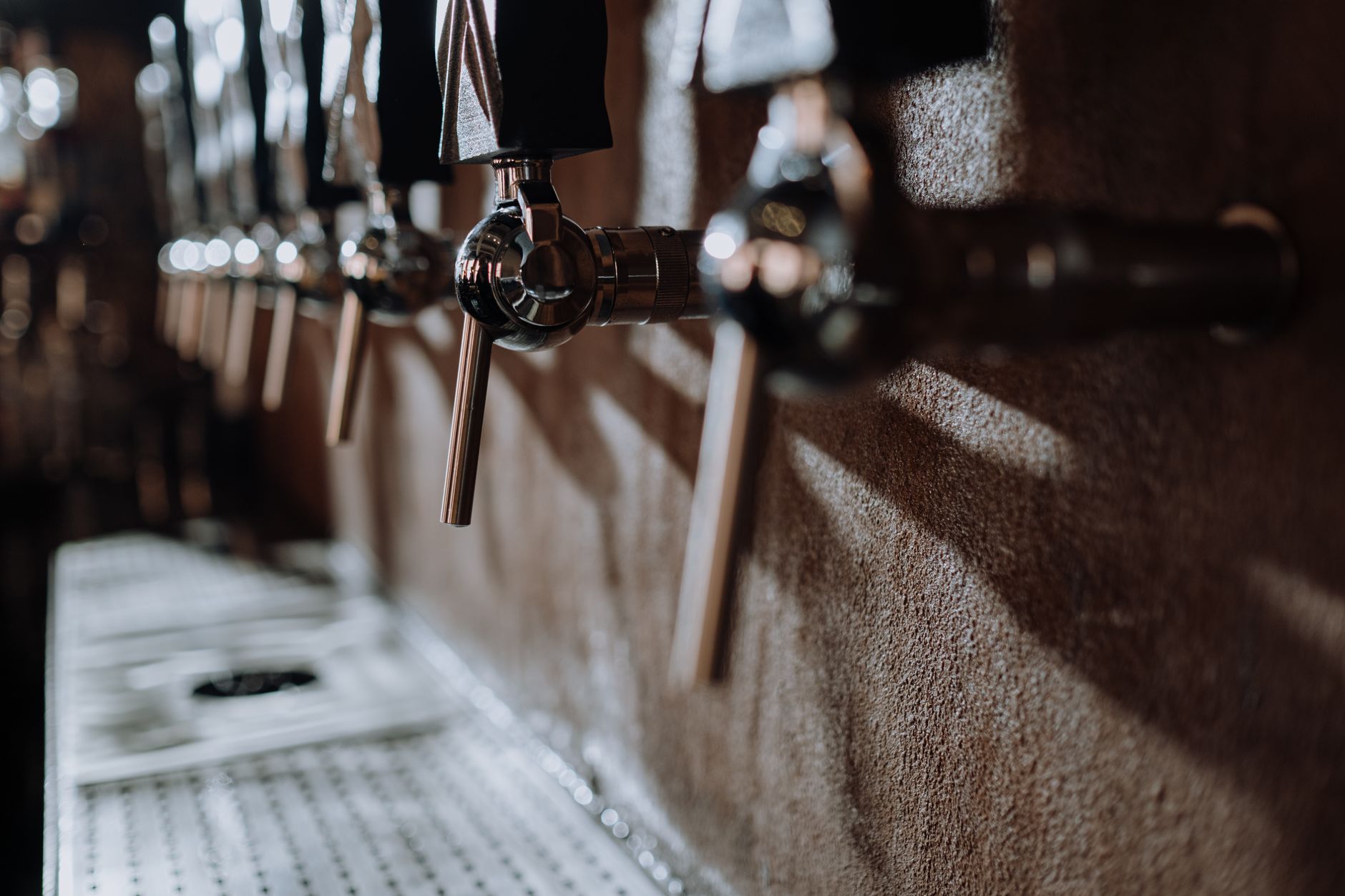 Row of beer taps in a brewery taproom