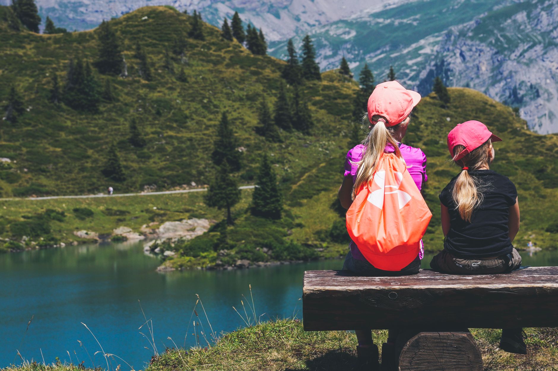Kids taking in a mountain lake view on a hike