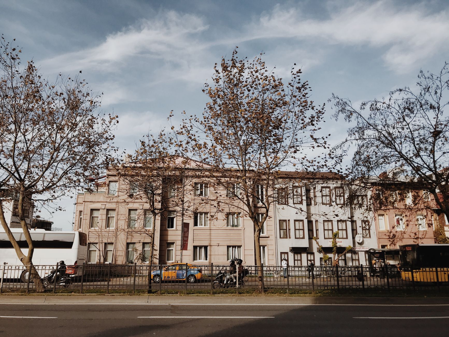 Historic buildings along a tree-lined street