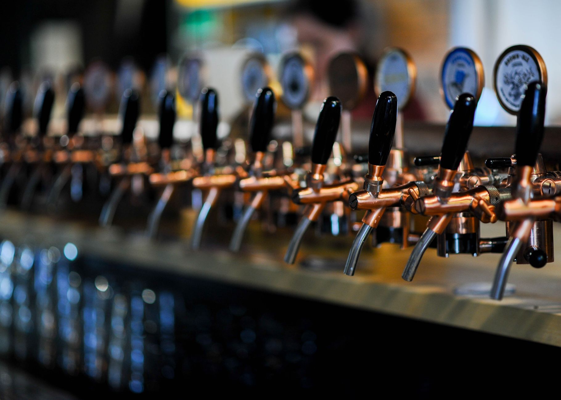 Row of craft beer taps at a Boulder bar