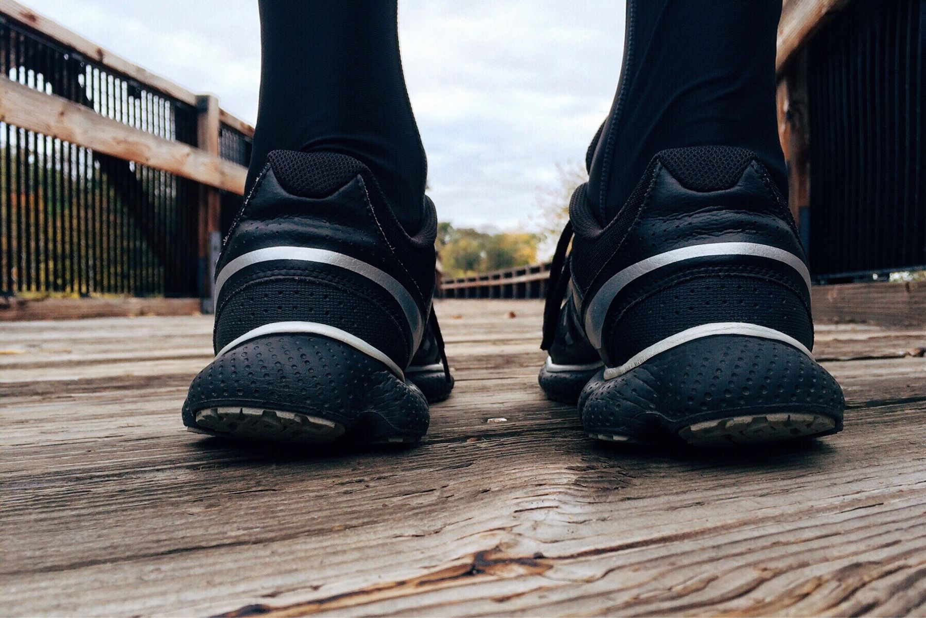 Running shoes on a trail bridge near Boulder