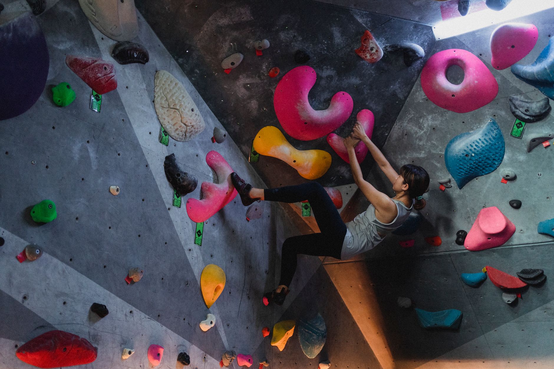 Climber on an indoor bouldering wall in Boulder