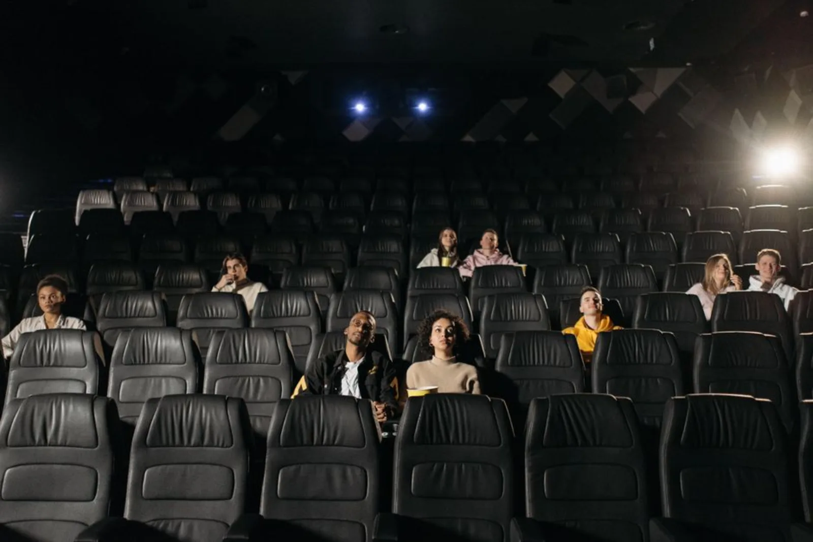 Audience watching a film premiere in a darkened theater, the kind of screening coming to Boulder for Sundance 2027