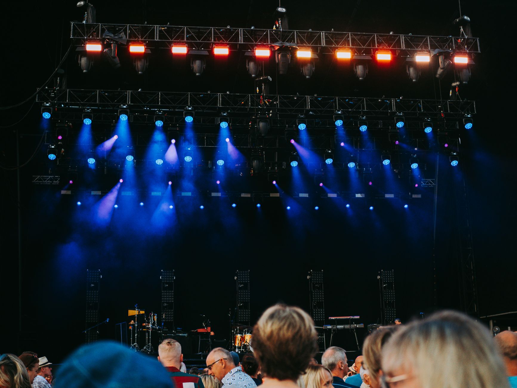 Concert crowd in front of a lit stage