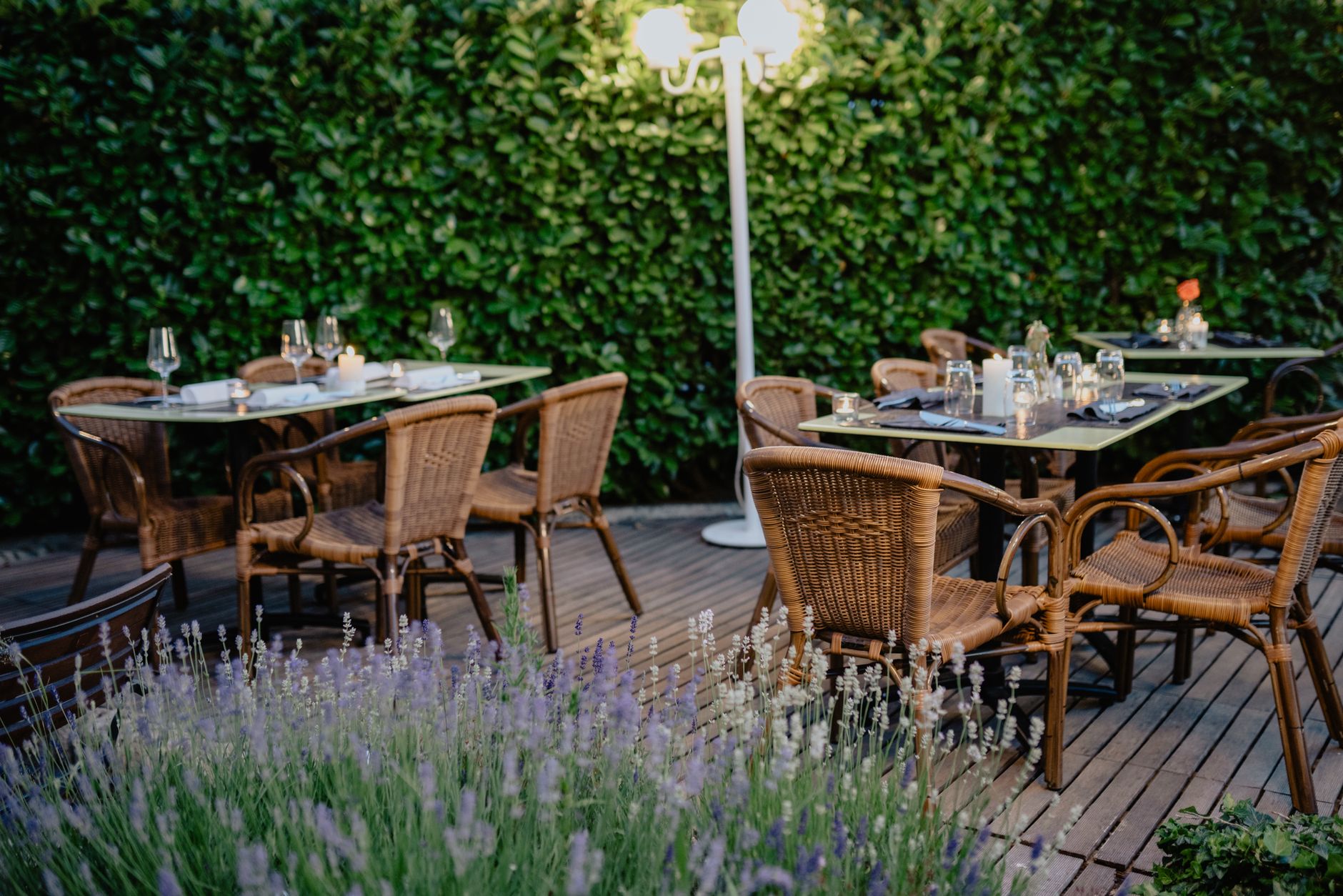 Diners on a restaurant patio in the evening