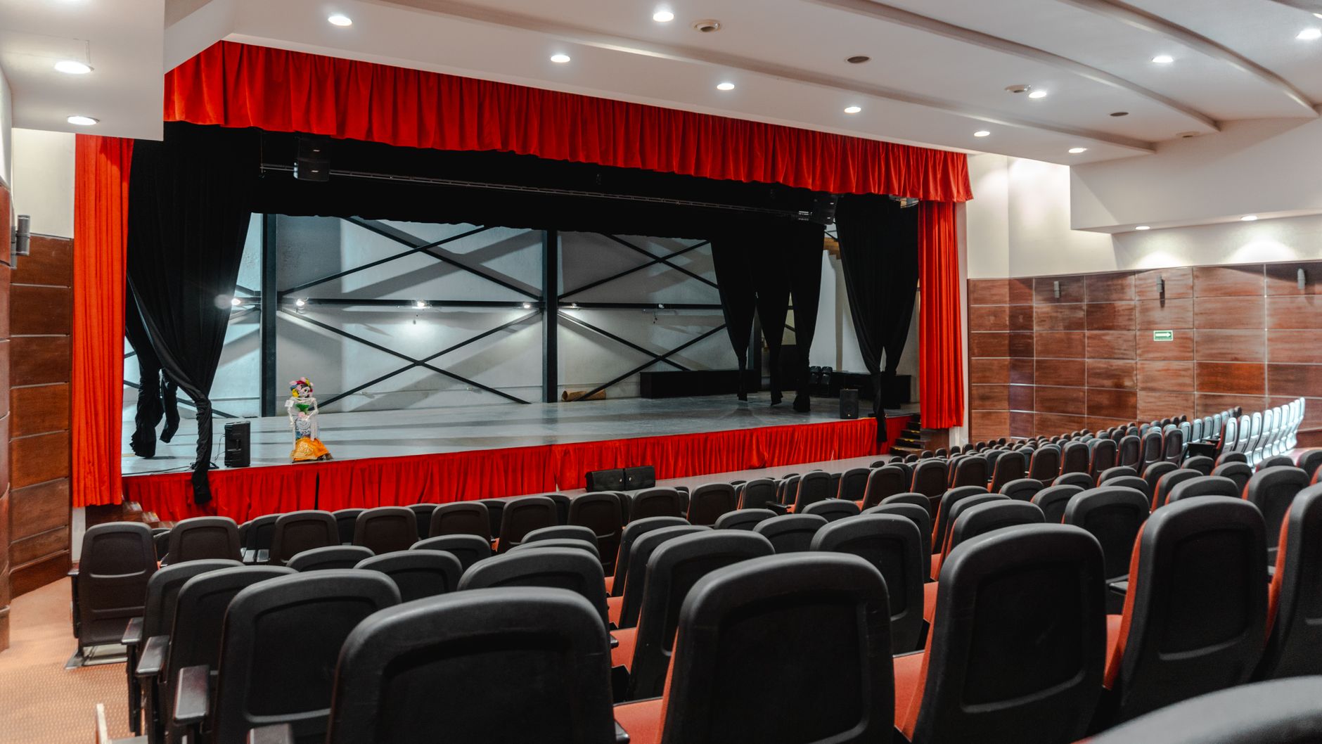 Red seats facing a theater stage