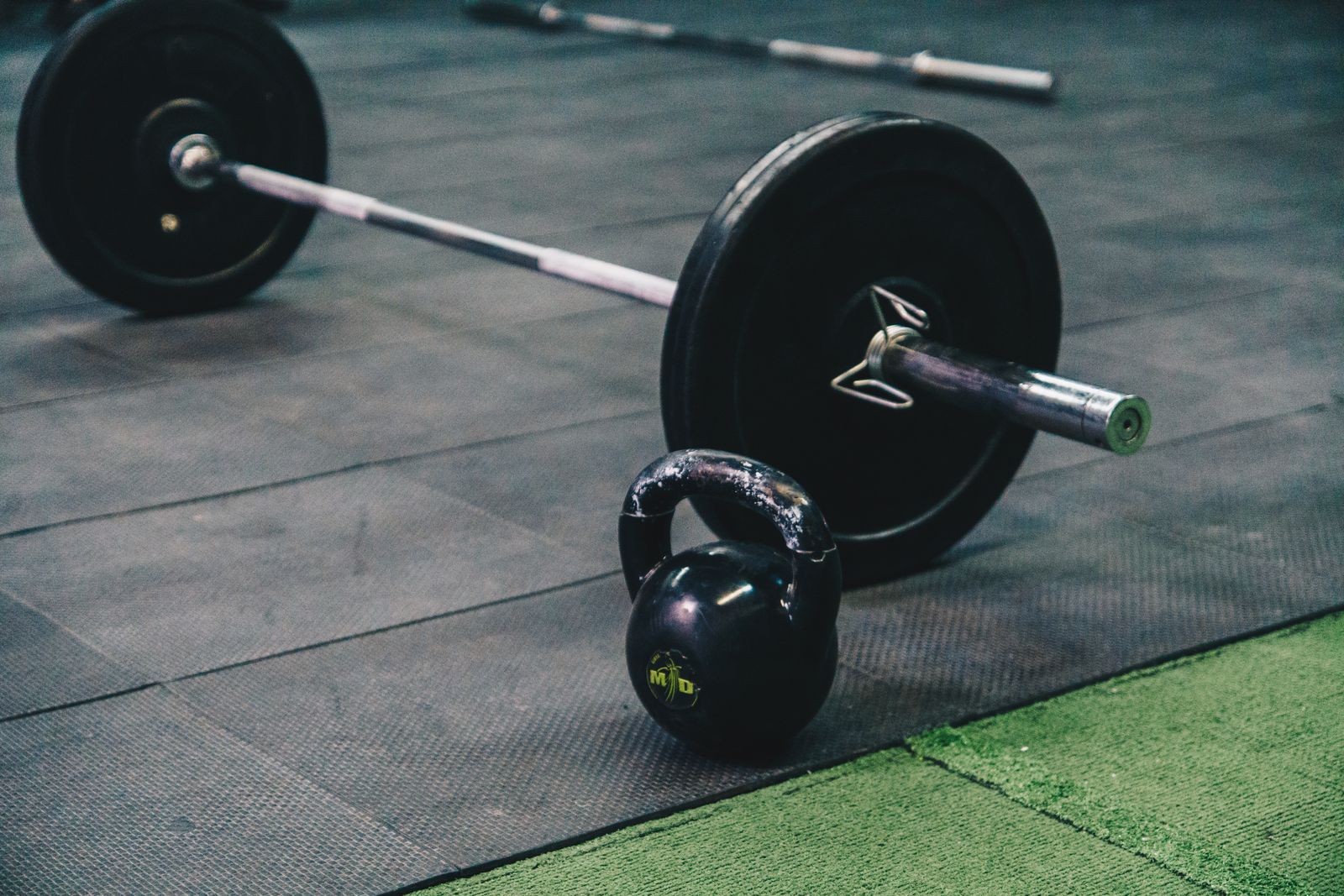 Barbell and kettlebell on a gym floor - best CrossFit gyms in Boulder