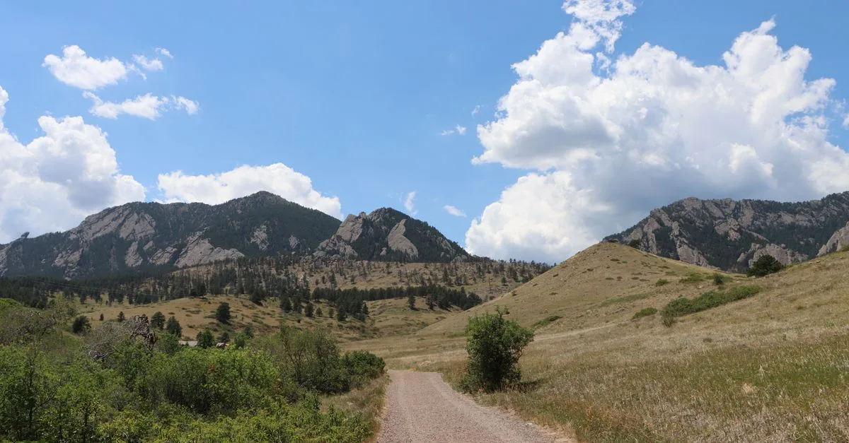 Gravel foothills trail with the Flatirons rising in the distance