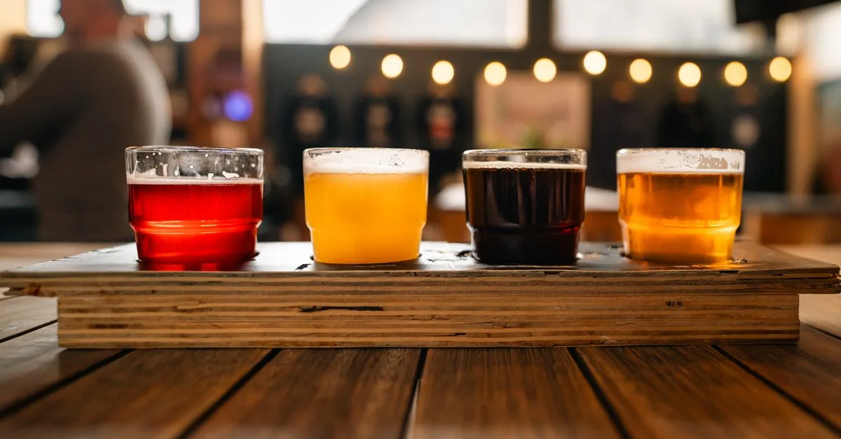 Craft beer flight in a taproom, evoking Gunbarrel's Boulder brewery district