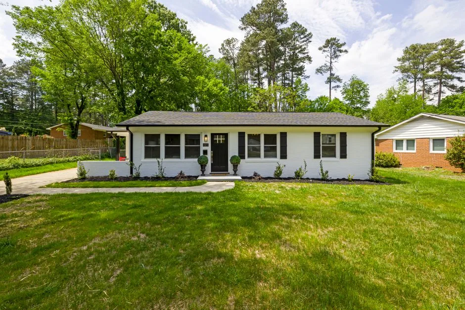 A single-story brick ranch house with a wide front lawn, the style common in Martin Acres