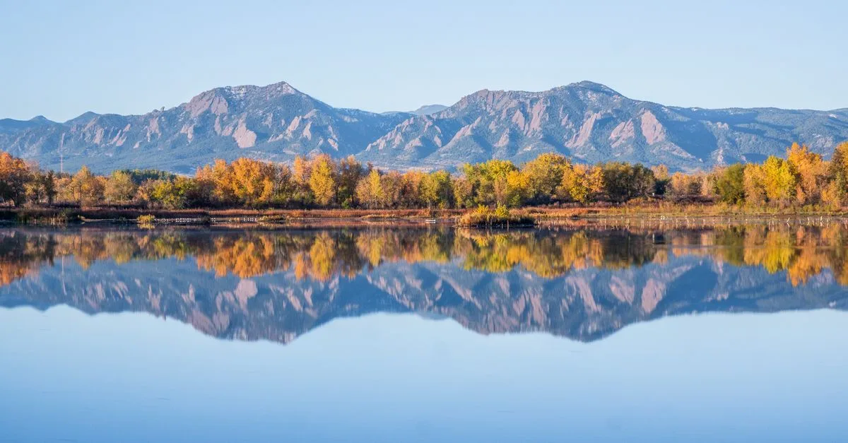 Still water reflecting the Flatirons near Boulder Reservoir, Colorado