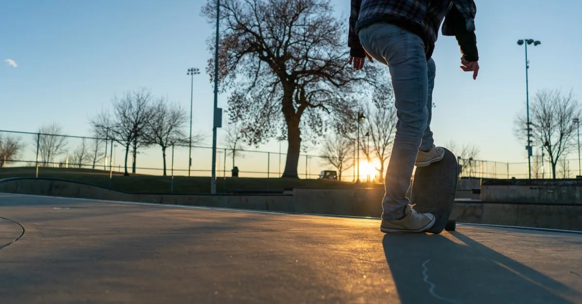 A skateboarder pauses at sunset at a Boulder, Colorado skate park